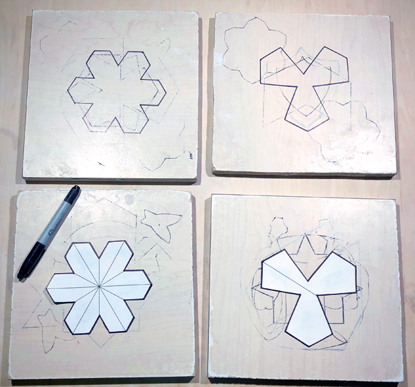 2 Print out the template for the tile shapes, cut out the shapes, and trace their outlines onto laminate boards using a permanent marker.