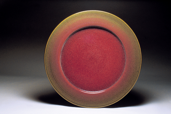 9 Winthrop Byers’ platter, 19 in. (48 cm) in diameter, wheel thrown, trimmed, low bisque fired, shiny iron brown glaze sprayed on back and rim, center is a copper red wood-ash glaze.