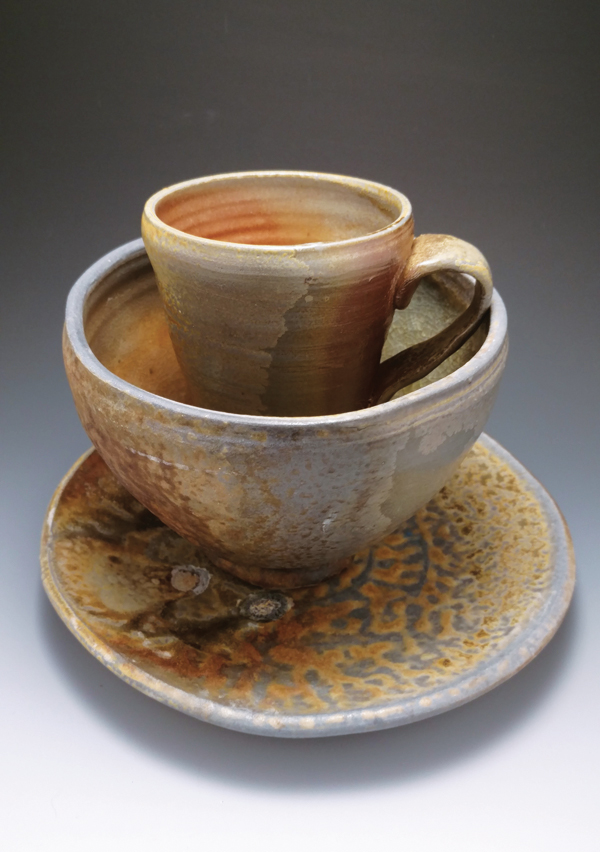 1 Tim Compton’s wood-fired dinner set, 10 in. (25 cm) in height (stacked), white stoneware, wood ash, fired to cone 12. Tim Compton is a stage-2 seller. He sells work in Indianapolis and online, but his primary focus is as the adult programs manager at the Indianapolis Art Center. 