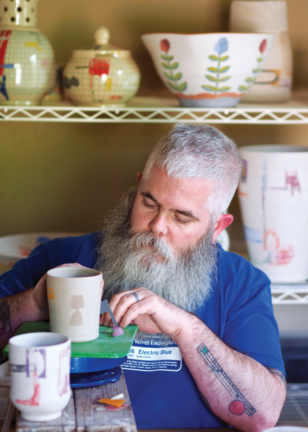 4 Mark Errol in his home studio, decorating cups, 2018. Photo: Glenn Josey.