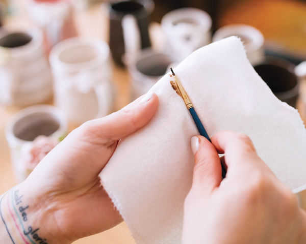 3 Occasionally wiping your brush down with a clean paper towel minimizes mistakes created by excess luster on your fingers.