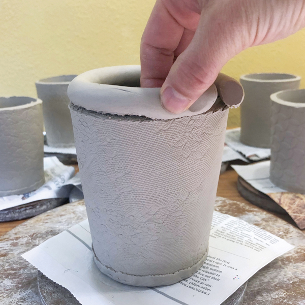 5 Add a scored coil to the top of the cup form and pinch to attach.