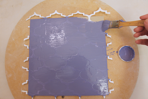 6 Paint underglaze over the stencil. After it loses its sheen, remove the stencil.