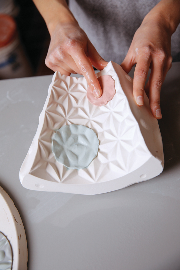 10 Press the pieces into the vase mold with a damp sponge and your fingers.
