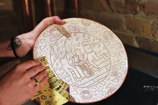 12 Sand your bisque-fired plate to remove any sharp bits from the sgraffito process.