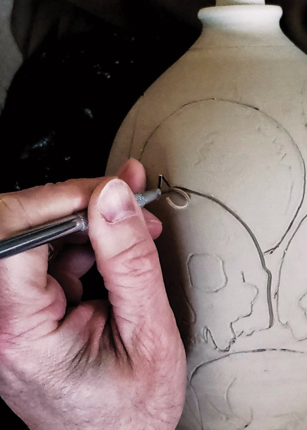 2 Using an angled carving tool, trace the imagery to create a bold outline around the form.