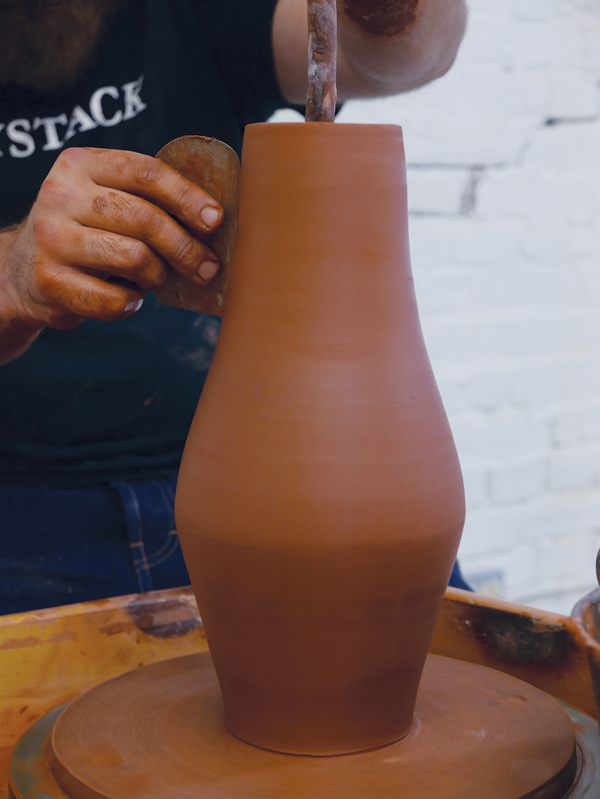 5 Blend the two sections together, compressing the bead of clay into the bottom.