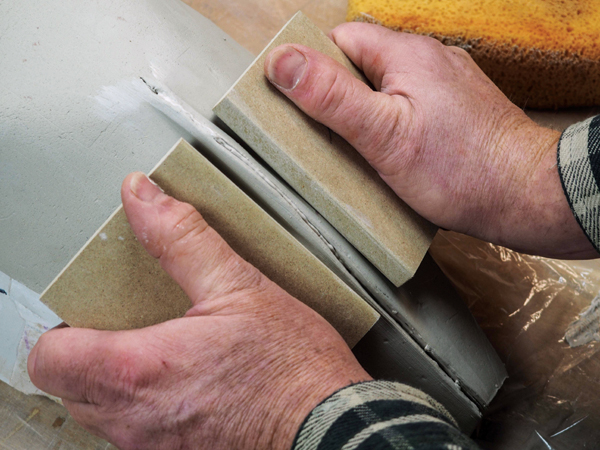 9 Use the smooth, angled edges of two boards to compress and close each seam.