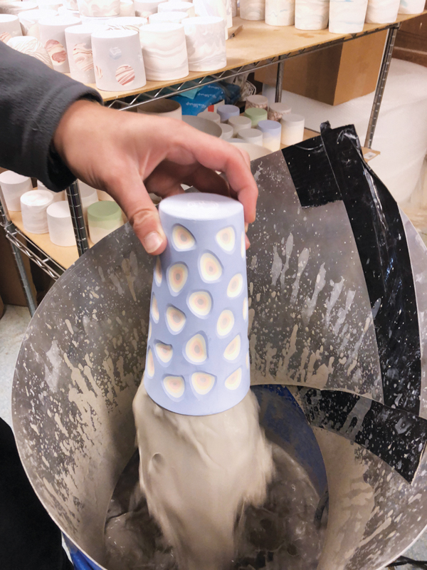 2 Glaze fountain in use, applying liner glaze to the interior of a layered and carved pint cup.