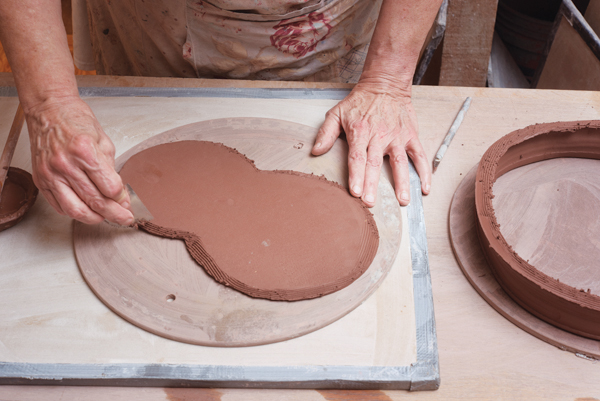 3 Score the perimeter of the slab as well as the bottom of the thrown ring, then apply slip to the scored areas.