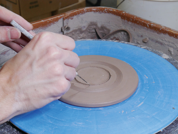 5 Cut a hole out of the center of the lid using a needle tool.