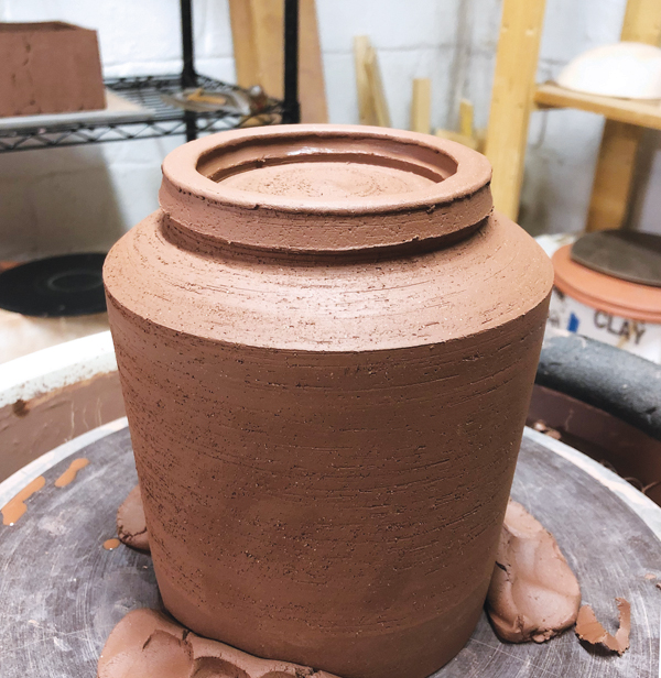 5 Add a coil to the bottom of the pot, then throw it to form the foot.
