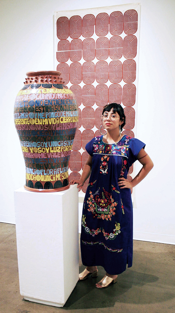 Gabo Martini poses with her work during the opening for “ Flor Morena,”  her first solo exhibition at Conduit Gallery, in Dallas, Texas, 2018.