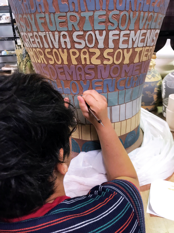 5 Martini carving letters on a terra-cotta urn for her BFA thesis exhibition at Texas State University, 2018.