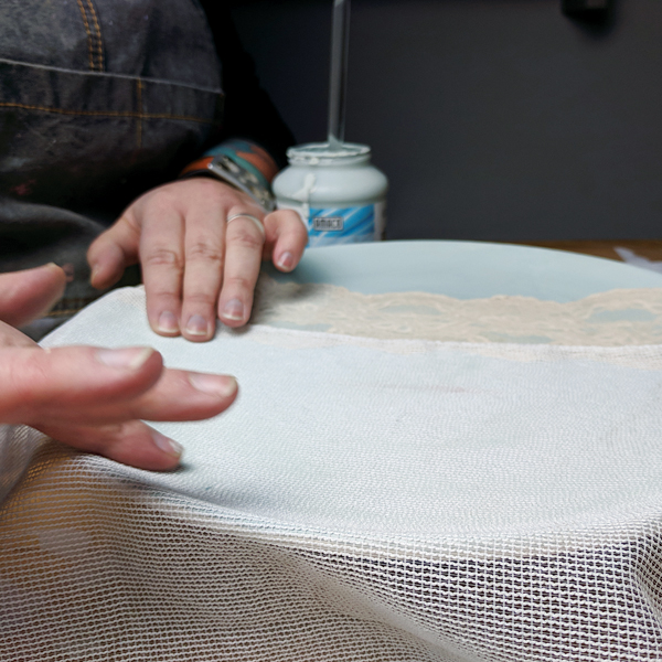 1 Apply a loose-weave fabric to slightly damp glaze. Pat gently to remove wrinkles.