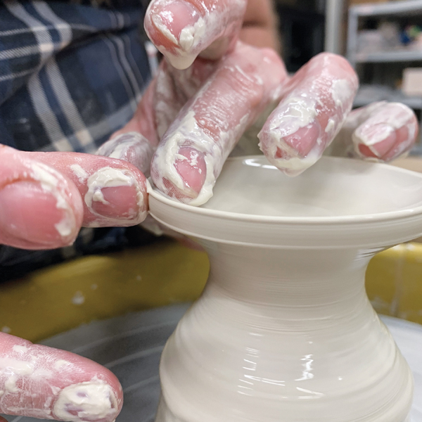 2 Throw the base of the cup, flattening the side of the rim to later attach to the wall.