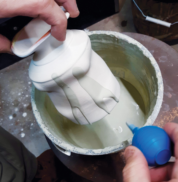 4 Apply a clear glaze, then use a bulb syringe to squirt colored glazes overtop.