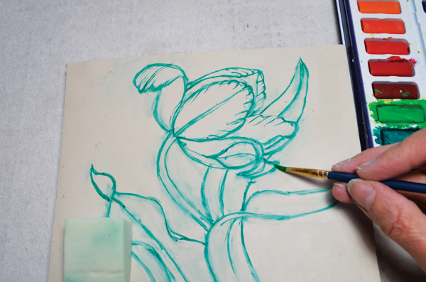 4 Sketch with watercolors directly onto the clay to create fluid lines for carving later.