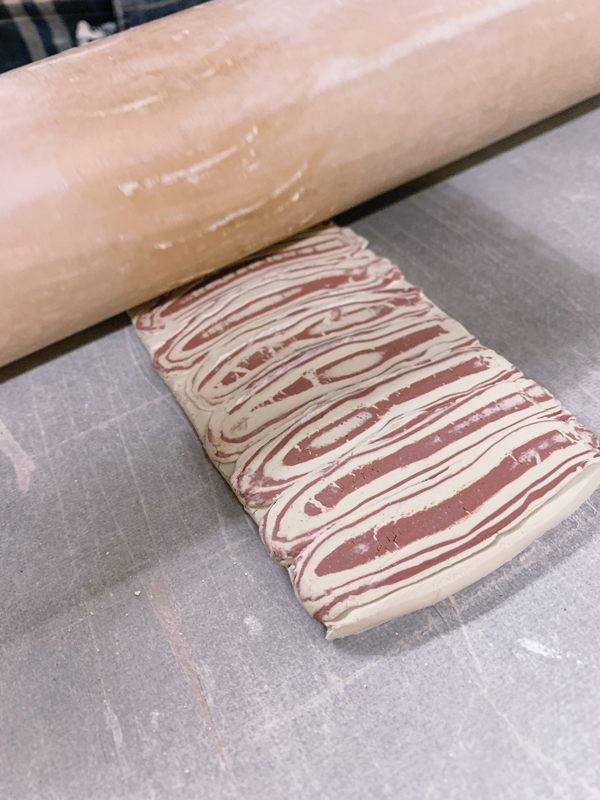 7 Stretch and compress the slab with a rolling pin to a thickness appropriate for the wall of the cup.