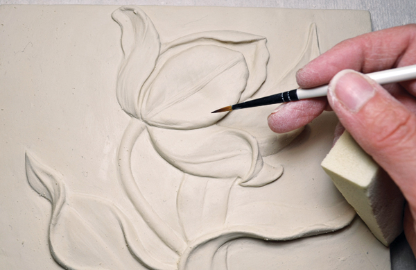 10 Use an assortment of tools and brushes to round edges and blend the added clay.
