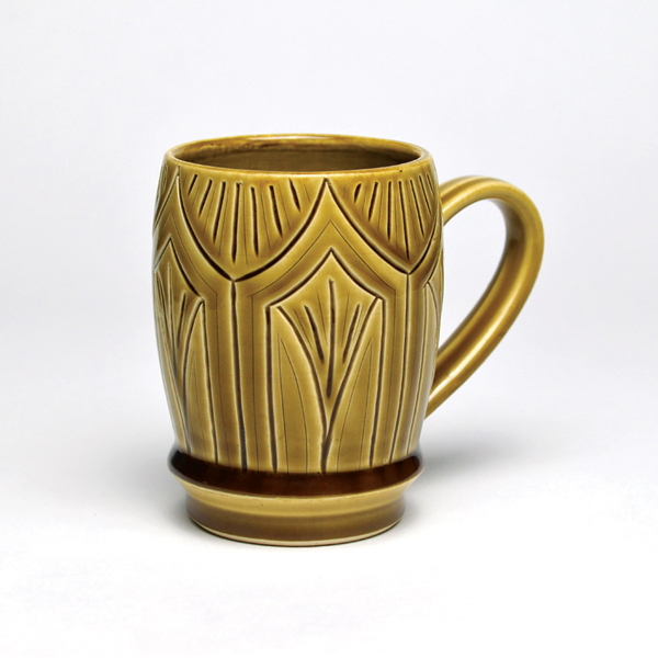 3 Philip Matthews’ amber celadon mug, first place winner, carved porcelain, fired to cone 6 in oxidation.