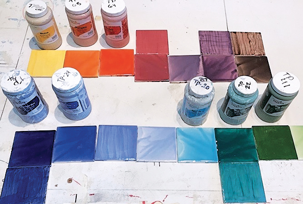 3 Square glazed tiles (4 1/4 inch), arranged in the spectrum, with 16-ounce jars of Amaco Teacher’s Palette glazes. 