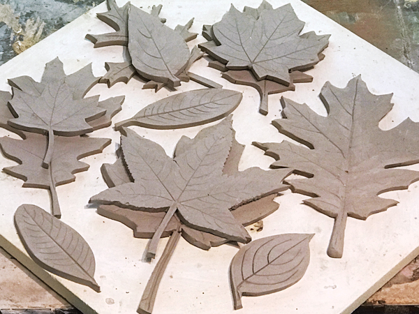 4 I traced around foam-core templates onto ¼-inch-thick slabs of white, low-fire stoneware, cut the leaf tiles out with an X-Acto blade, then incised the leaf veins with a pencil. 