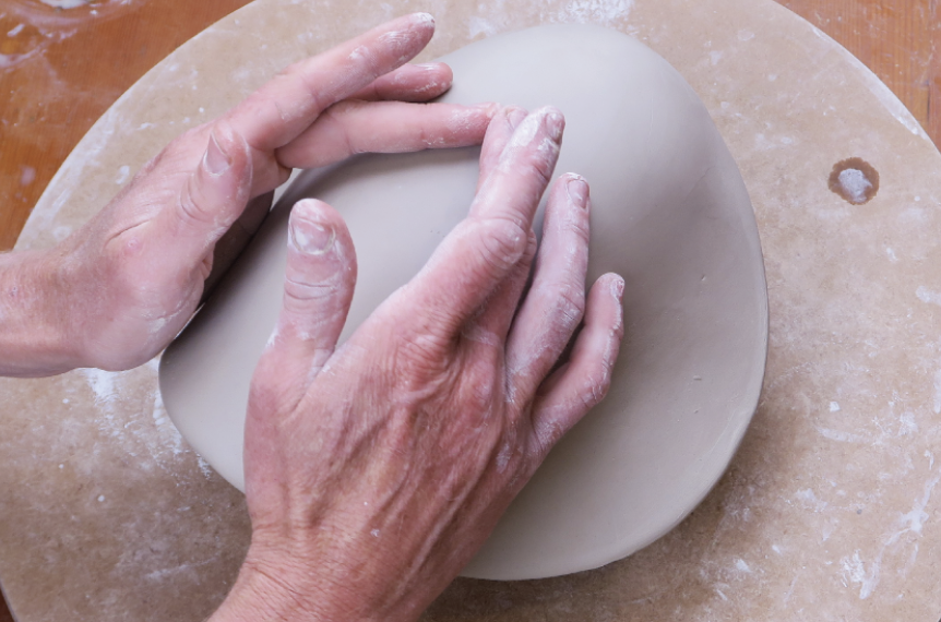 4 Compress and conform the slab onto the mold using your thumbs and fingers in a collaring motion.