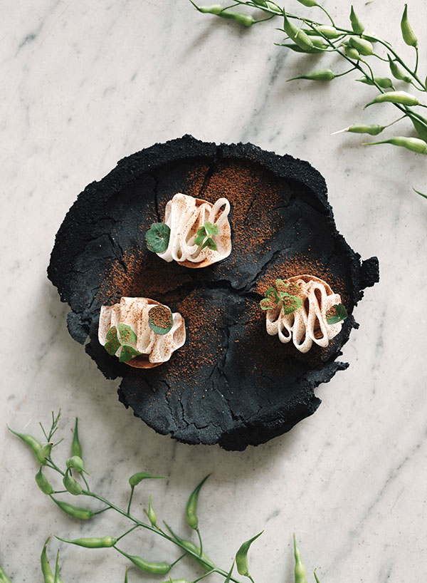 Chef André Chiang’s black radish tarte served on Adam Knoche’s plate during a Steinbeisser Experimental Gastronomy event in Amsterdam, the Netherlands. Photo: Kathrin Koschitzki.