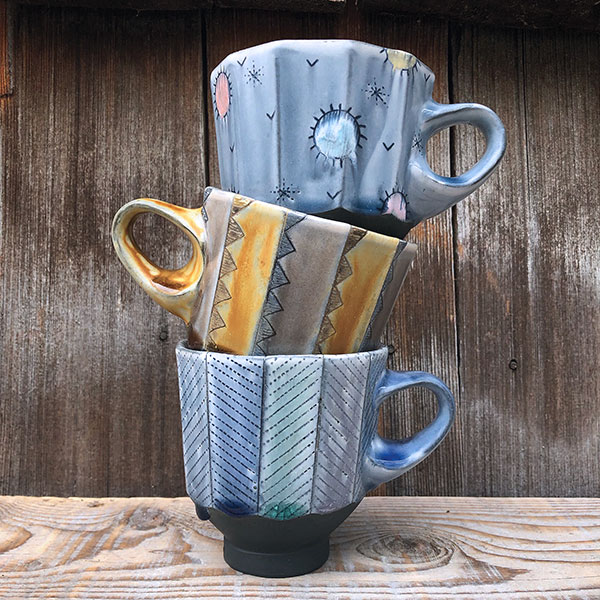 Dodecagonal handled cups, 5 in (13 cm) in width, stained porcelain with slip and glaze, fired to cone 8 in an electric kiln, 2018.