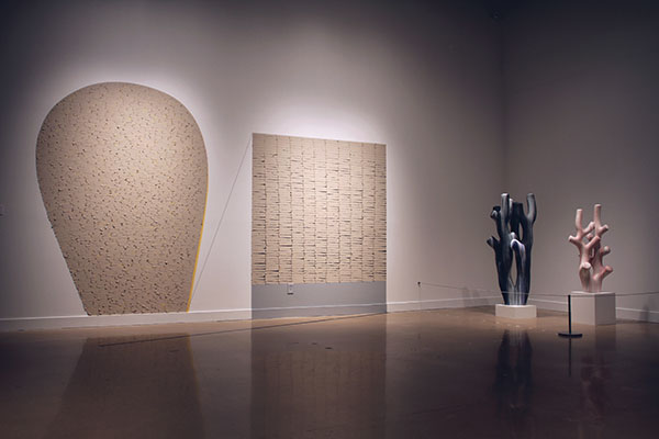 3 Installation view (left to right): Yewen Dong’s Much Ado About Nothing 1, 14 ft. 5 in. (4.4 m) in width, unfired clay, paint, thread, duct tape, 2019; Trey Hill’s Nightfall, 4 ft. 6 in. (1.4 m) in height, ceramic, underglaze, 2016; Trey Hill’s A Slight Blush, 3 ft. 3 in. (1 m) in height, ceramic, underglaze, 2019. 1–3 Courtesy of the Ulrich Museum of Art.