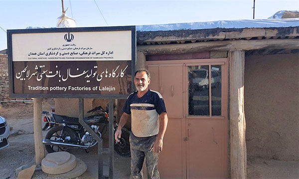 2 Novin Aslan Islami outside of his family-run studio in Lalejin in 2017. Official efforts to promote and support the potteries have led to increased interest from tourists. Islami says that his pottery receives a growing number of Italian tour groups. 