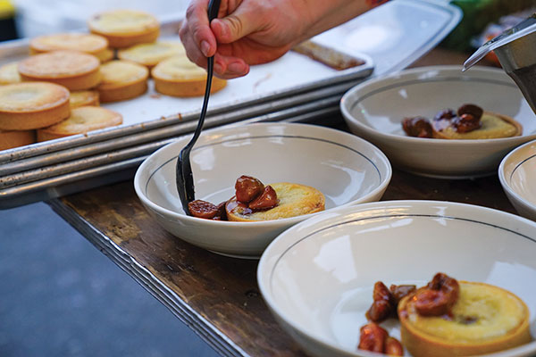 7 Chef Kelly Fields of Willa Jean in New Orleans, Louisiana, plating up a dessert during a dinner at Billy Reid Shindig in Florence, Alabama.