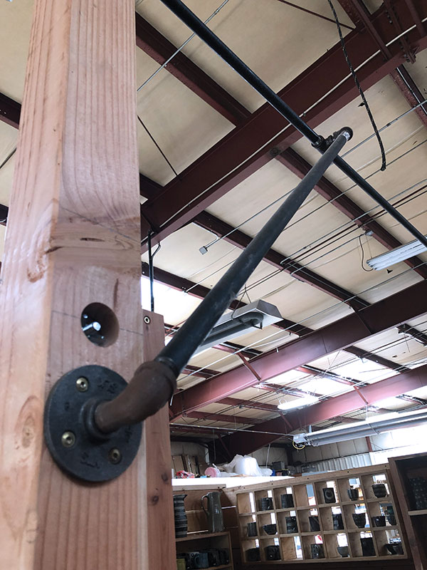 5 A black iron pipe stabilizes the front posts, and is used for mounting lights.