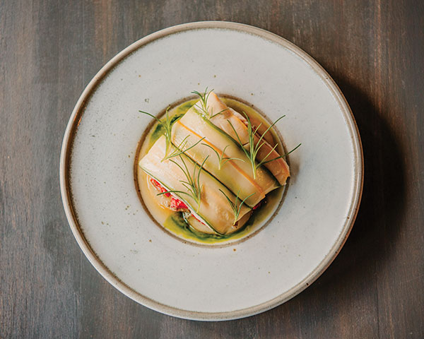 1 Il Covo’s sea bream recipe shown on Patrick Yeung’s plate, 9 1/4 in. (24 cm) in diameter, stoneware, glaze. Photo: Maria Giuliana.