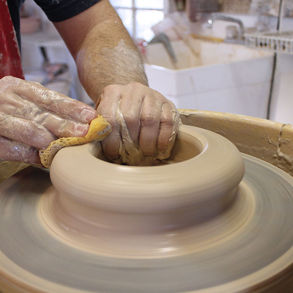 1 Center the 4 pounds of clay on the wheel, opening the interior 4–5 inches.