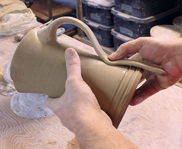 26 Attach the lower end of the handle with a firm press and wiggle.