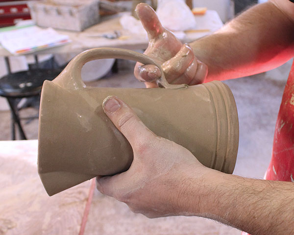 28 Shape the handle, giving it a more rounded look by pulling on the lower section.