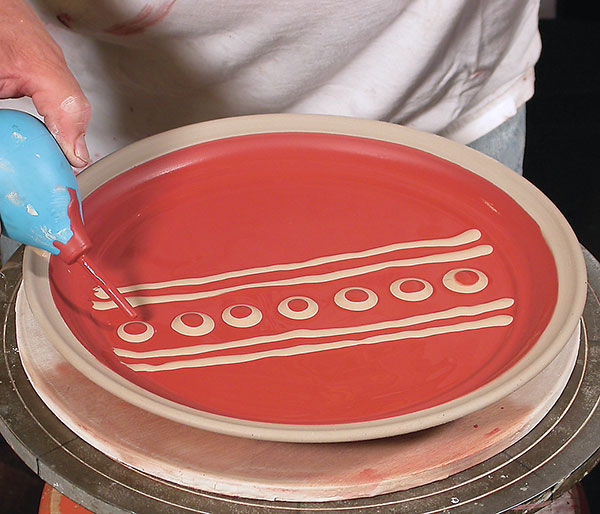 1 Dotting a multi-colored-slip pattern using a slip trailer.