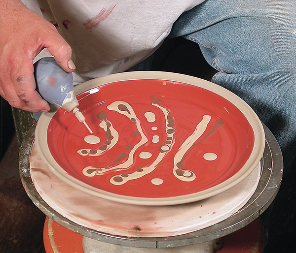 3 Preparing to marble by adding slips over an iron-colored slip.