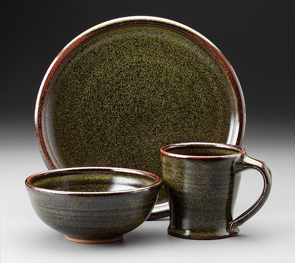 2 Plate, bowl, and mug, wheel-thrown stoneware, teadust glaze, gas fired to cone 10 in reduction, 2018. 