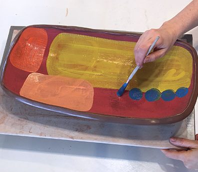 4 Apply contrasting colors of underglaze over top of it, to add depth to the surface.
