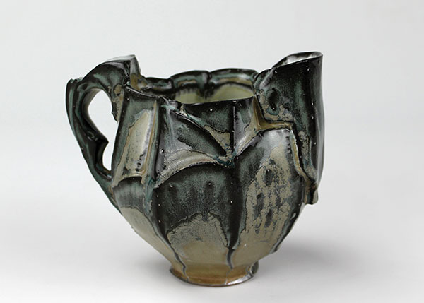 8 Katie Fee’s pitcher, wheel-thrown and altered groggy stoneware, fired to cone 11 in reduction in a gas soda kiln.