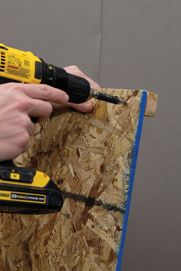 1 Frame the walls by attaching 1-inch pine strips to the smooth side of the OSB panels.