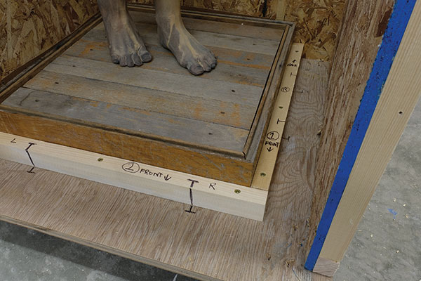 4 Secure the base in place by mounting wood strips on the floor. This will greatly help gallery staff in repacking the work.