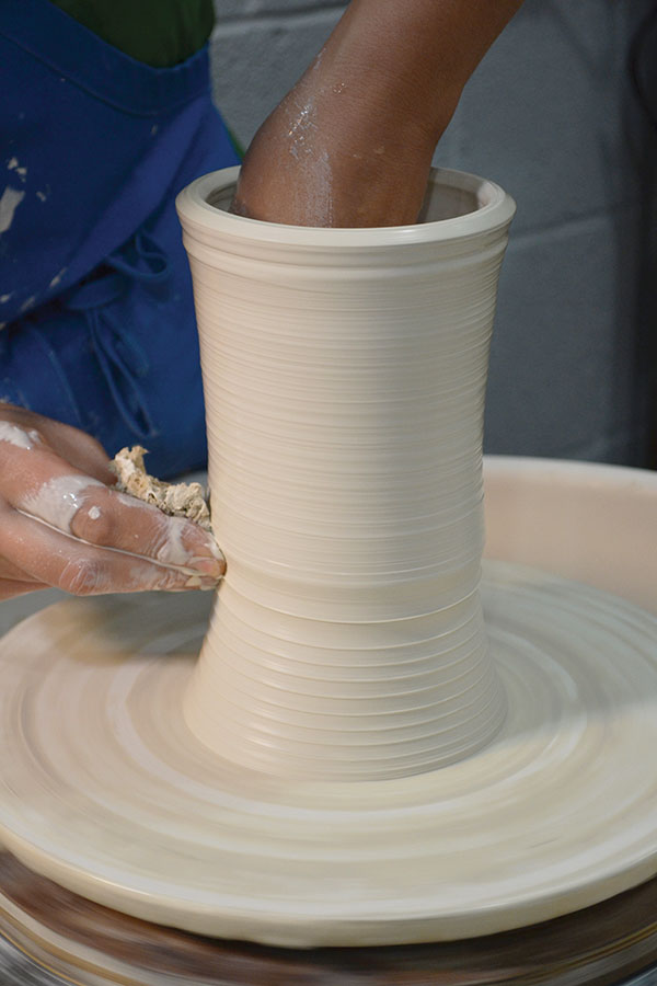 1 Throw a tall cylinder, leaving plenty of clay at the top to stretch it wider later on.