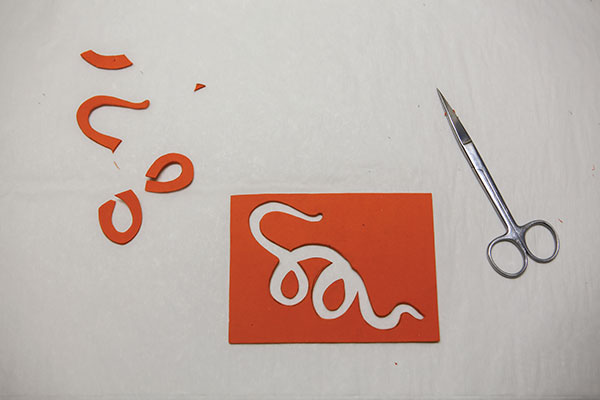 2 Use fine-pointed scissors to cut out a negative of the image. Save the smaller pieces that fill any negative spaces.