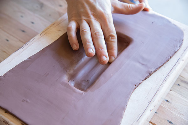 5 Press a slab into the plaster mold of the butter stand. 