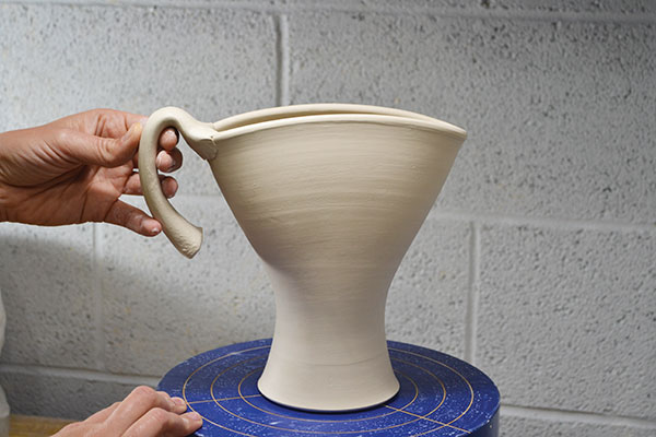 7 Attach the top of the handle to the top of the vase at one of the corners.