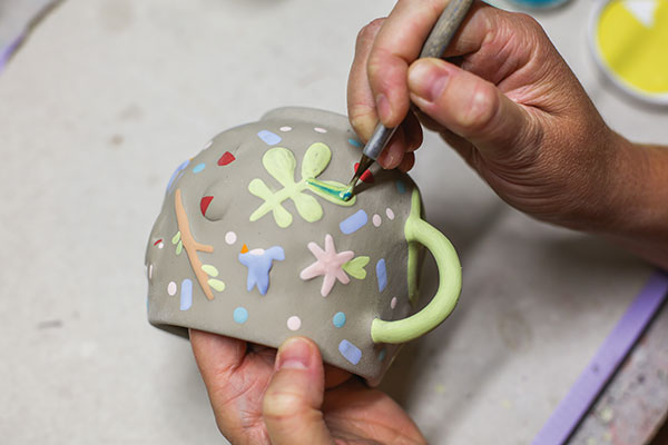 10 Load the brush with multiple underglaze colors to add depth and detail.